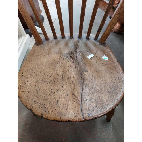 20 - A Yealmpton type Windsor chair. With stick back and solid seat.Evidence of historic woodworm, possib... 