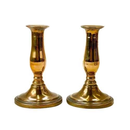 200 - Two similar early 18th century brass candlesticks. Each on a petal base, height 19.5cm, together wit... 