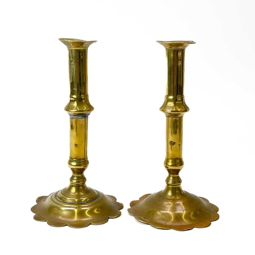 200 - Two similar early 18th century brass candlesticks. Each on a petal base, height 19.5cm, together wit... 