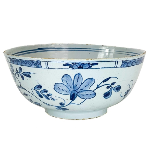 203 - A Delft blue and white bowl. Mid 18th century, painted with Chinoiserie flowers, diameter 20cm.