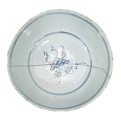 203 - A Delft blue and white bowl. Mid 18th century, painted with Chinoiserie flowers, diameter 20cm.