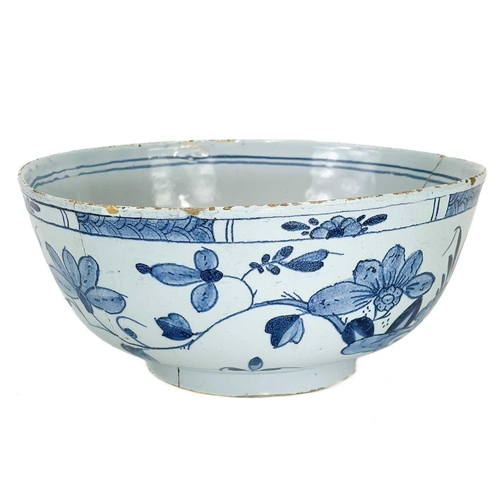 203 - A Delft blue and white bowl. Mid 18th century, painted with Chinoiserie flowers, diameter 20cm.