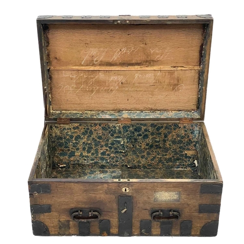 204 - A large Victorian oak dome top silver chest. Ironbound, labelled for Charles Willams, silversmiths, ... 