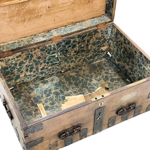 204 - A large Victorian oak dome top silver chest. Ironbound, labelled for Charles Willams, silversmiths, ... 