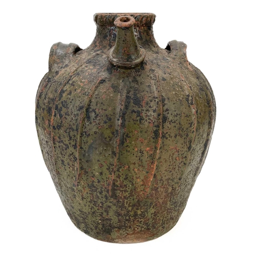 209 - A large French terracotta walnut jar. With a pouring spout and three lug handles and ribbed decorati... 