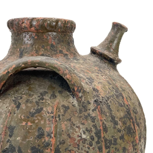 209 - A large French terracotta walnut jar. With a pouring spout and three lug handles and ribbed decorati... 