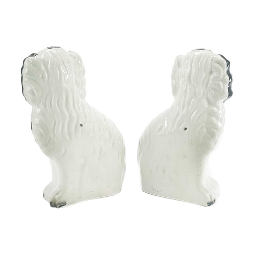 215 - A pair of Victorian Staffordshire pottery black and white figures of spaniels. Height 24.5cm.Right h... 