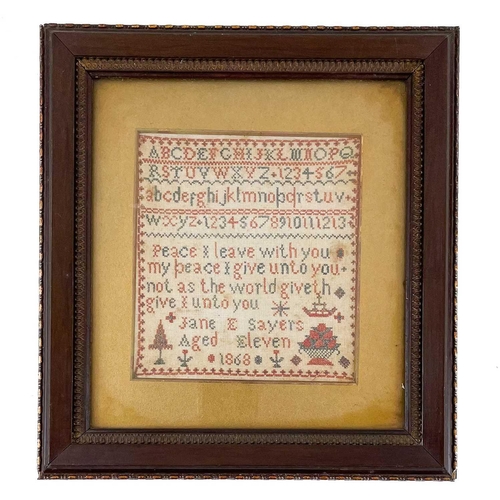 217 - A Victorian woolwork sampler Dated 1868, by Jane E. Sayers, aged 11, worked with the alphabet and ve... 