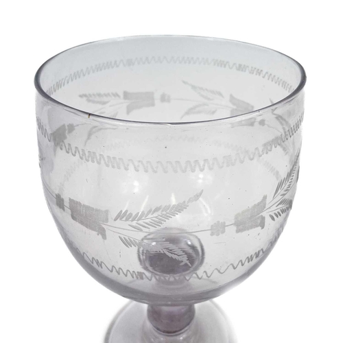 219 - A large 19th century glass rummer. The knopped stem with an amethyst hue the bowl with acid etched d... 