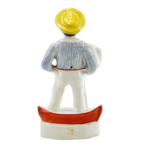 220 - A Victorian Staffordshire figure of a sailor. Standing on a boat and holding a flag, height 34.5cm.C... 