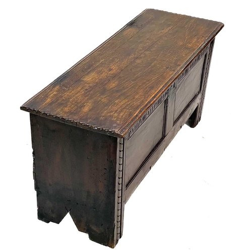 229 - An oak six plank coffer. 18th century, with a carved frieze, on stile feet, height 49cm, width 107cm... 