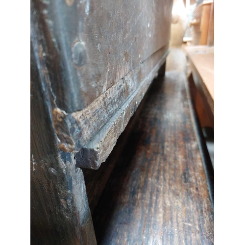 229 - An oak six plank coffer. 18th century, with a carved frieze, on stile feet, height 49cm, width 107cm... 