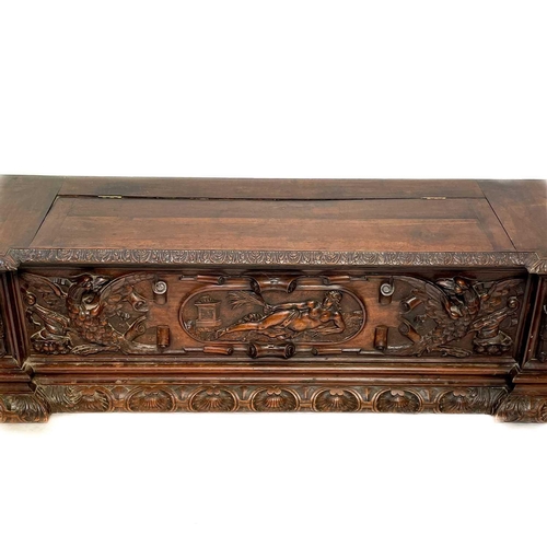 231 - A late 19th century walnut carved cassone. Carved in the Renaissance style the central panel with a ... 