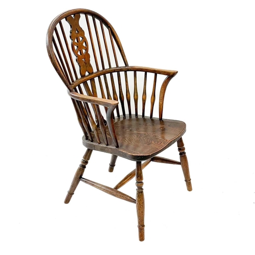 235 - A pair of 19th century ash, elm and beech Windsor chairs. The pierced back splats with cartwheel mot... 