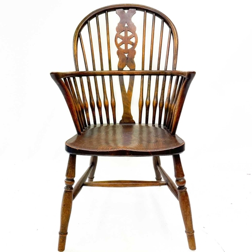 235 - A pair of 19th century ash, elm and beech Windsor chairs. The pierced back splats with cartwheel mot... 