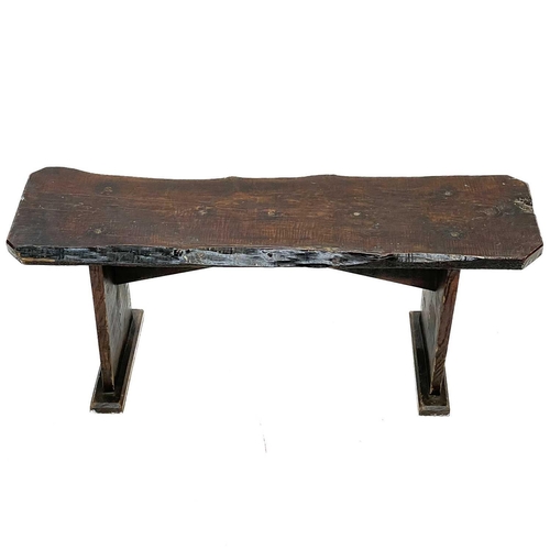 238 - A rustic elm form or bench. Circa 1900, raised on plank end supports, height 41.5cm, width 102cm, de... 