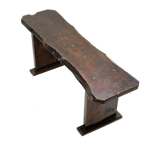 238 - A rustic elm form or bench. Circa 1900, raised on plank end supports, height 41.5cm, width 102cm, de... 