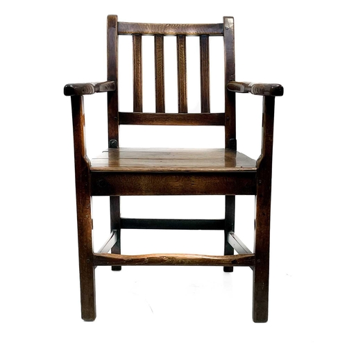 239 - A George III ash and oak country made elbow chair. With slat back and solid plank seat, with a squar... 