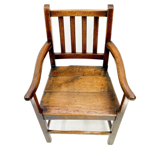 239 - A George III ash and oak country made elbow chair. With slat back and solid plank seat, with a squar... 