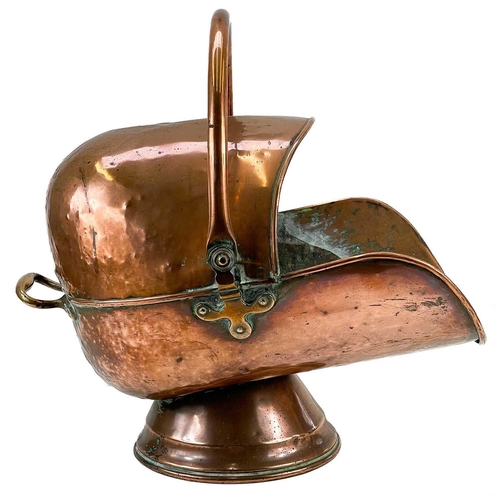 244 - A Victorian copper coal scuttle. Of helmet form, with swing handle, height 52cm.