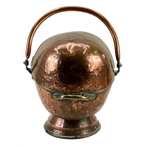 244 - A Victorian copper coal scuttle. Of helmet form, with swing handle, height 52cm.