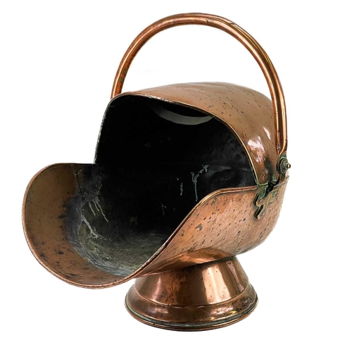 244 - A Victorian copper coal scuttle. Of helmet form, with swing handle, height 52cm.