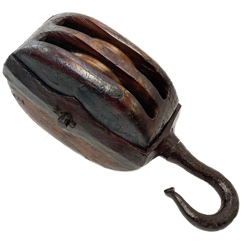 250 - A large 19th century teak and iron bound ships block and tackle. Marked L F, length 71cm.