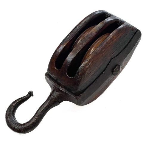 250 - A large 19th century teak and iron bound ships block and tackle. Marked L F, length 71cm.