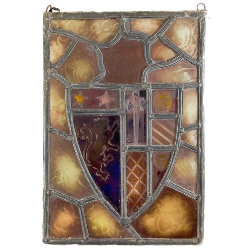 252 - A stained glass leaded panel bearing a coat of arms. 31.5cm x 22cm.Some wear commensurate with age, ... 