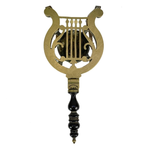 253 - A Victorian Longfields patent brass and steel trivet. With turned ebonised handle and hinged lyre sh... 