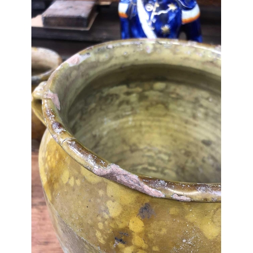 26 - A 19th century French pottery twin handled confit pot. With mustard glaze, height 30cm diameter 21.5... 