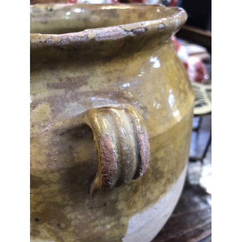 26 - A 19th century French pottery twin handled confit pot. With mustard glaze, height 30cm diameter 21.5... 