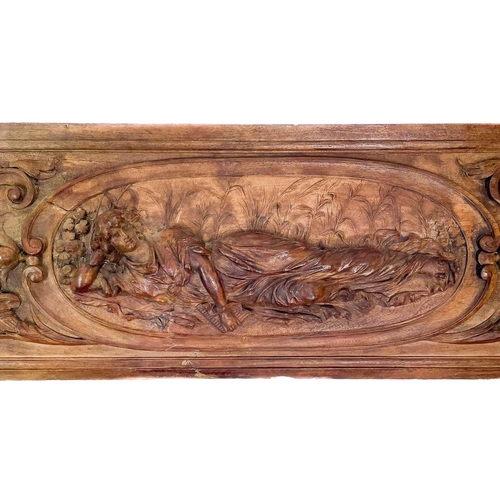 263 - A 19th century French walnut high relief carved panel. Carved with a classical female figure reclini... 