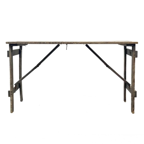 29 - An oak folding trestle table. Branded GVI to the underside, height 75cm, width 136.5cm, depth 68cm.T... 