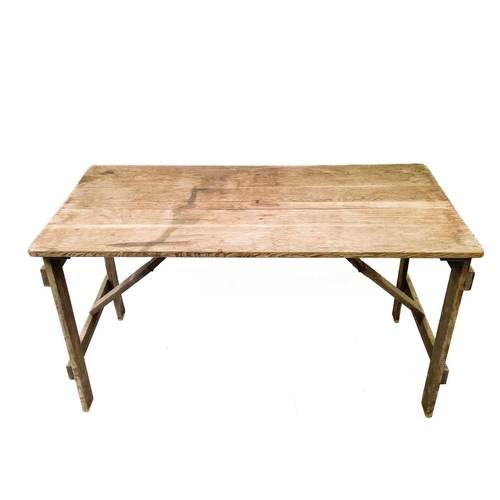 29 - An oak folding trestle table. Branded GVI to the underside, height 75cm, width 136.5cm, depth 68cm.T... 