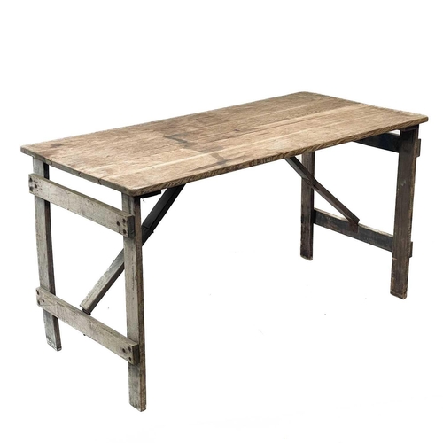 29 - An oak folding trestle table. Branded GVI to the underside, height 75cm, width 136.5cm, depth 68cm.T... 