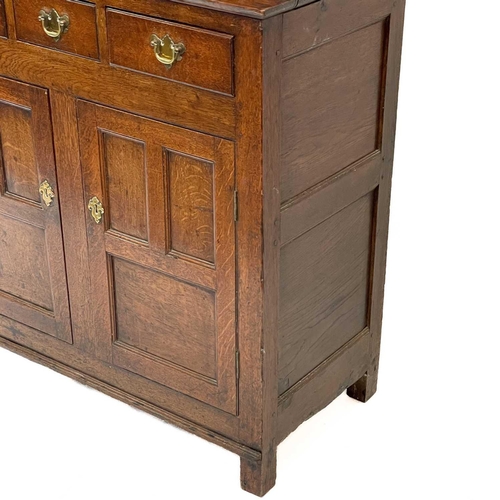 3 - A late George III Welsh oak cupboard Deuddarn The cornice with drop finials above two doors, the pro... 