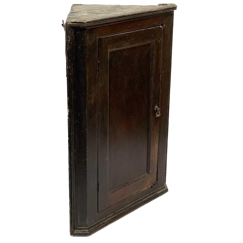 36 - A Georgian oak corner cupboard. Height 104cm width 74cm depth 42.5cm.