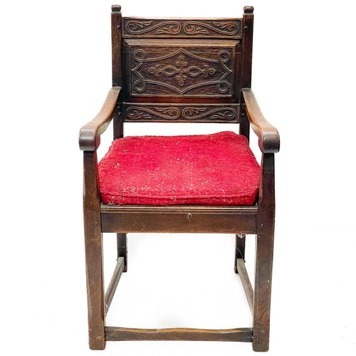 41 - A late Victorian oak hall arm chair. With carved back panel on square stretchers, height 91cm width ... 