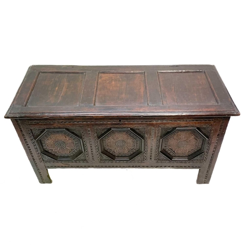 44 - A 17th century oak coffer. With three carved front panels, lift up the rectangular lid on block feet... 