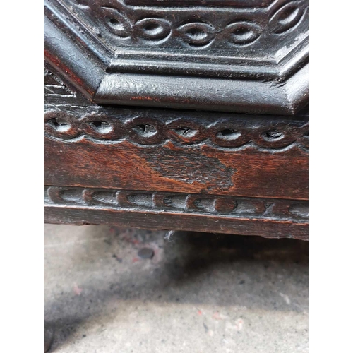 44 - A 17th century oak coffer. With three carved front panels, lift up the rectangular lid on block feet... 