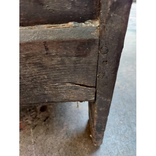 44 - A 17th century oak coffer. With three carved front panels, lift up the rectangular lid on block feet... 