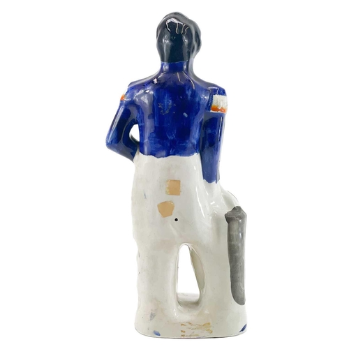 46 - A Victorian Staffordshire figure of Louis Napoleon. Standing beside a pillar, the bas with raised ti... 