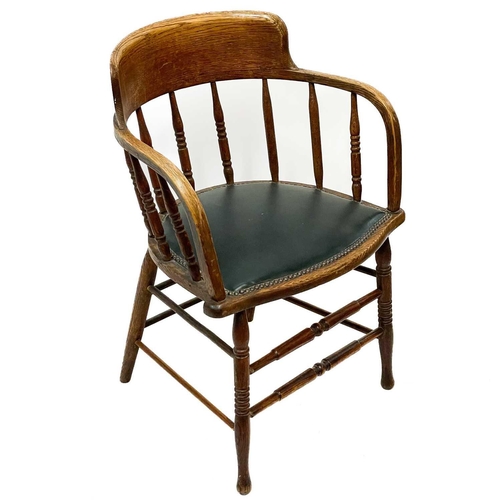 47 - An early 20th century oak bow smokers chair. With leather seat, height 79cm width 57cm depth 50cm.