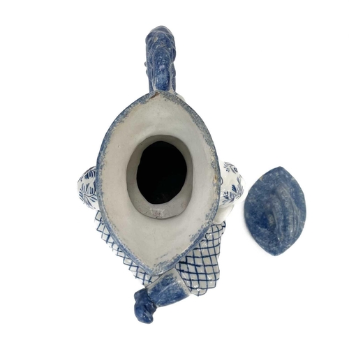 52 - A Deflt blue and white character jug and cover as Mr Punch. Circa 1900, the portly figure modelled s... 