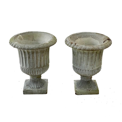 57 - A pair of reconstituted stone garden urns. Height 32cm, width 25cm, depth 25cm.