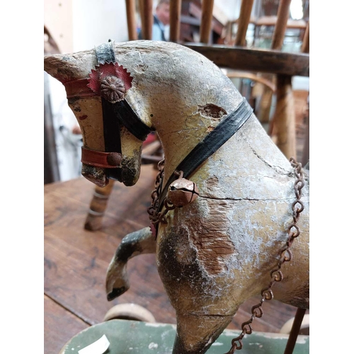 64 - A child's painted toy pull-along horse. Early 20th century, piebald decoration, on a green painted b... 