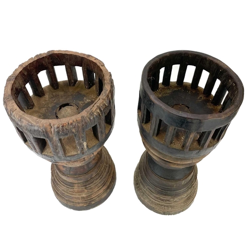 70 - A pair of unusual large candle holders. Made from the hardwood hubs of a wagon, with pierced tops, h... 