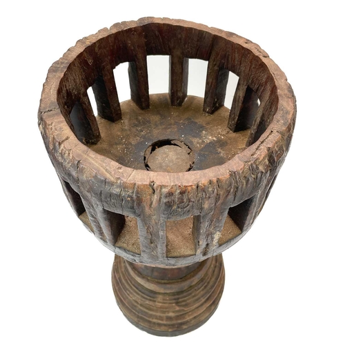 70 - A pair of unusual large candle holders. Made from the hardwood hubs of a wagon, with pierced tops, h... 