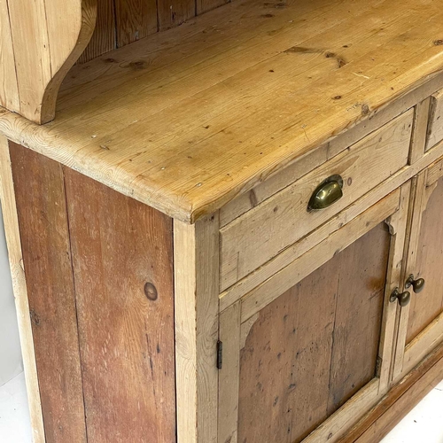 71 - A Victorian pine dresser. The upper part with two glazed doors, the lower part with two drawers and ... 